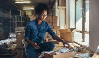 Women working at a table preparing an customers order.