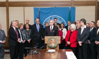 Washington State Director Patrick Connor at governor's signing-room podium