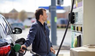 Man Filling Gasoline Fuel In Car Holding Nozzle